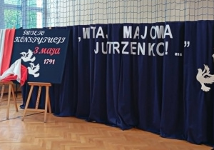 Dekoracja szkolnej akademii z okazji Święta Konstytucji 3 Maja w sali gimnastycznej